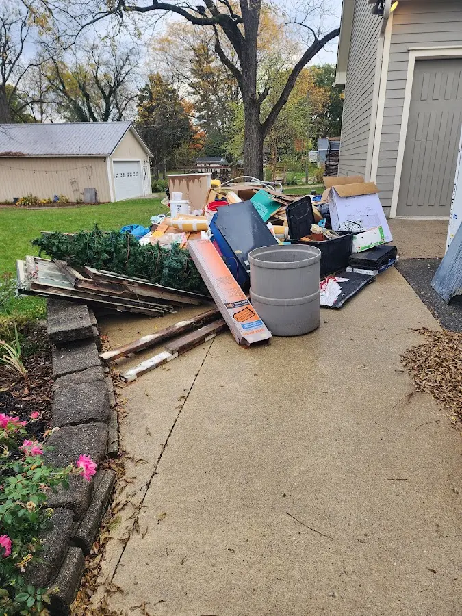 Dumpster being loaded with debris for Estate Cleanout Dumpster Rental in Miami Shores